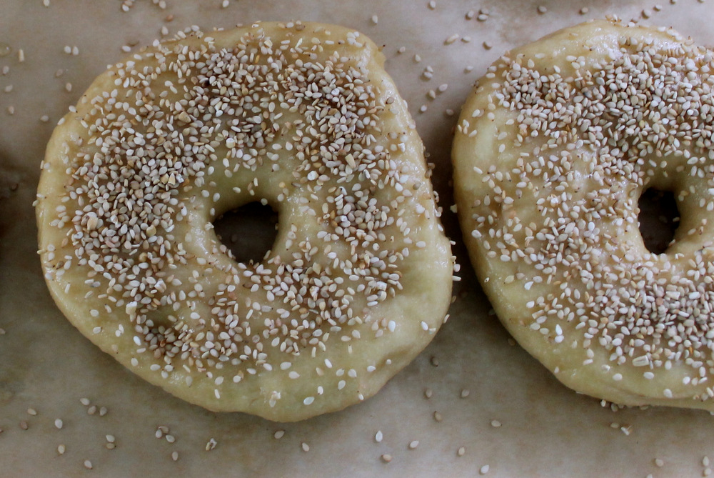 After the bagels have come out of the water bath, they will be a little wrinkly and deflated. They’ll also be wet and sticky, so it’s a good time to sprinkle on toppings. Photo: Kate Williams