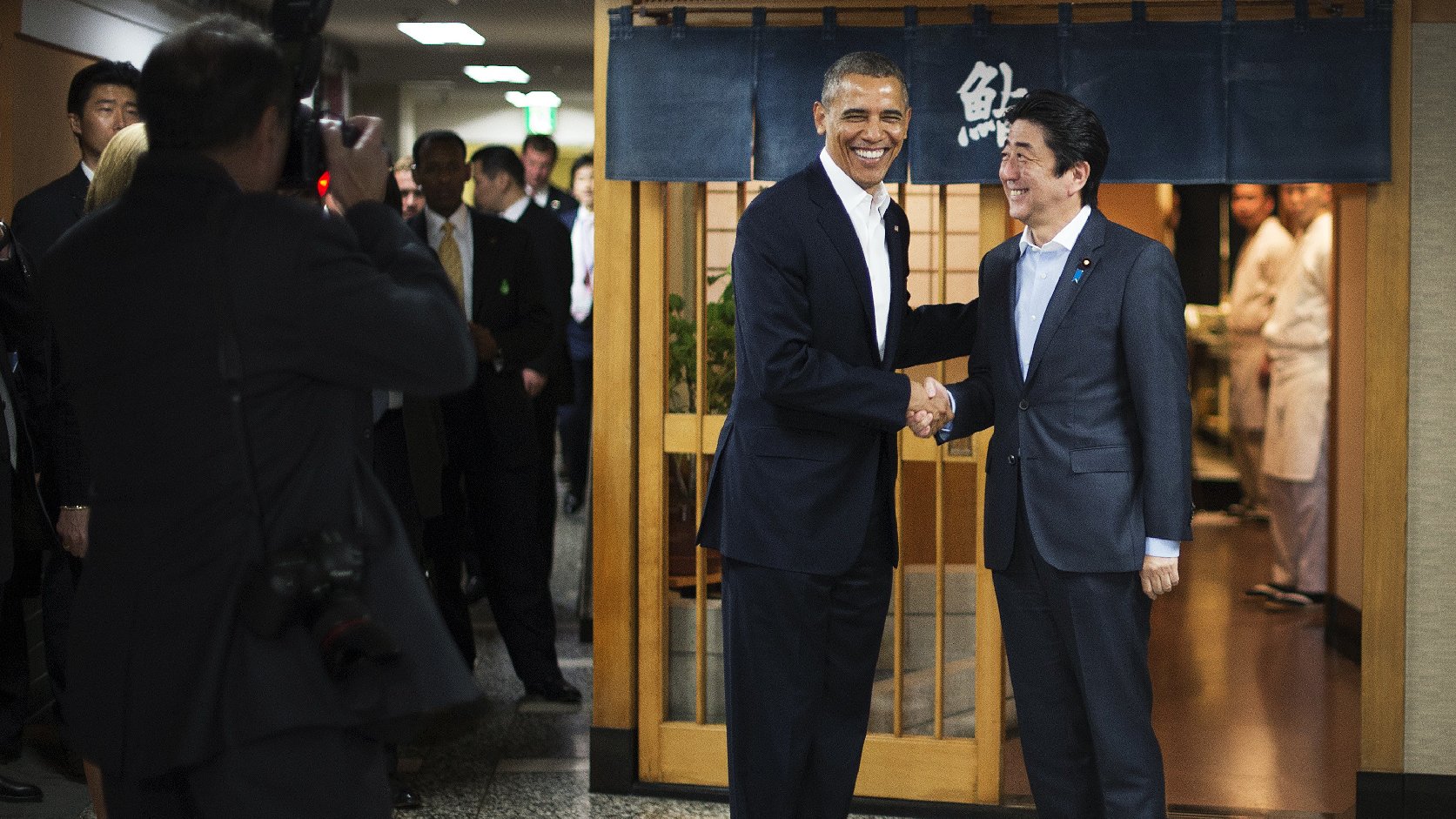 President Obama shakes hands with Japanese Prime Minister Shinzo Abe before a private dinner at Sukiyabashi Jiro restaurant in Tokyo on Wednesday. At Sukiyabashi Jiro, people pay a minimum $300 for 20 pieces of sushi chosen by the patron, Jiro Ono. Photo: Jim Watson/AFP/Getty Images