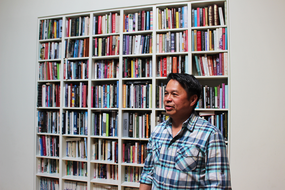 Charles Phan at home in front of his bookcase. Photo: Wendy Goodfriend