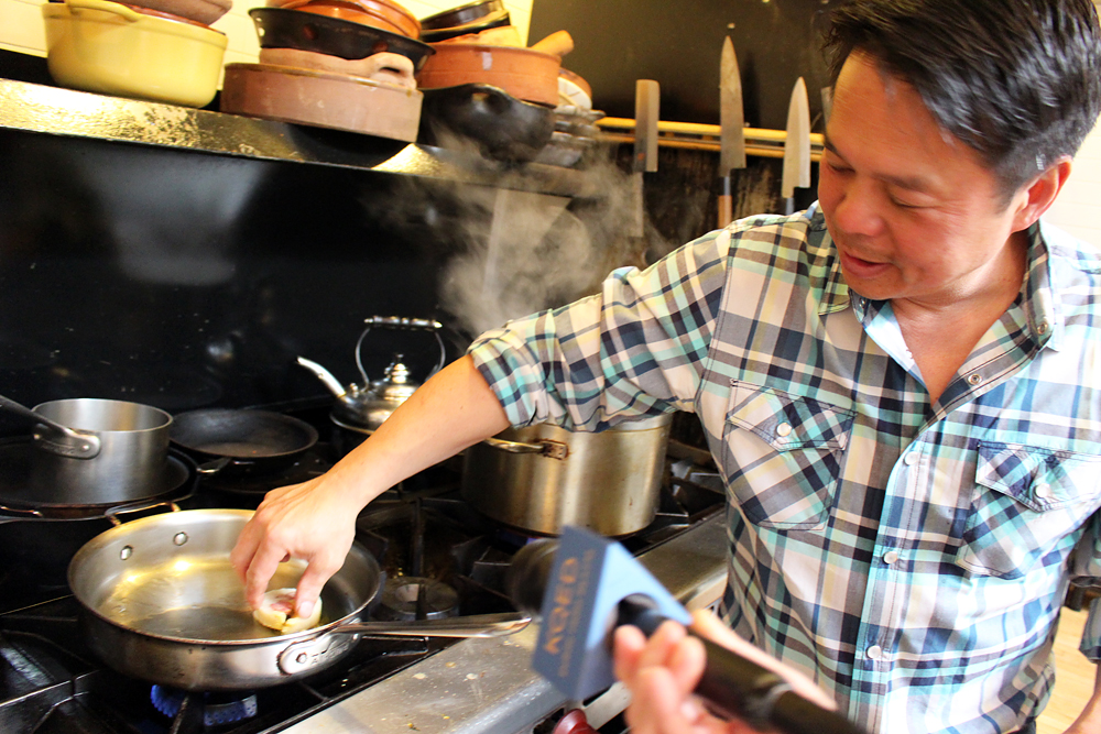 Charles Phan cooking sliced banh chưng. Photo: Wendy Goodfriend
