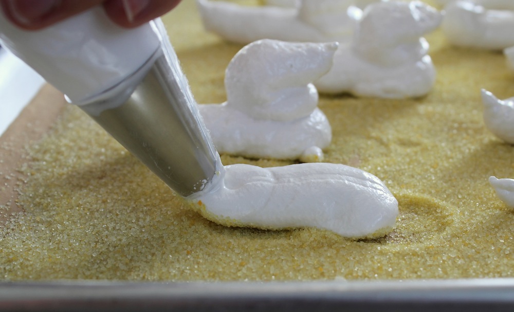 Start by piping the body of the Peep on to the sugar-lined baking sheet. Photo: Kate Williams