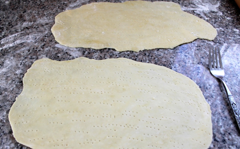 Use a fork to poke holes across the entire cracker sheet. These holes will prevent the matzo from forming giant bubbles. Photo: Kate Williams