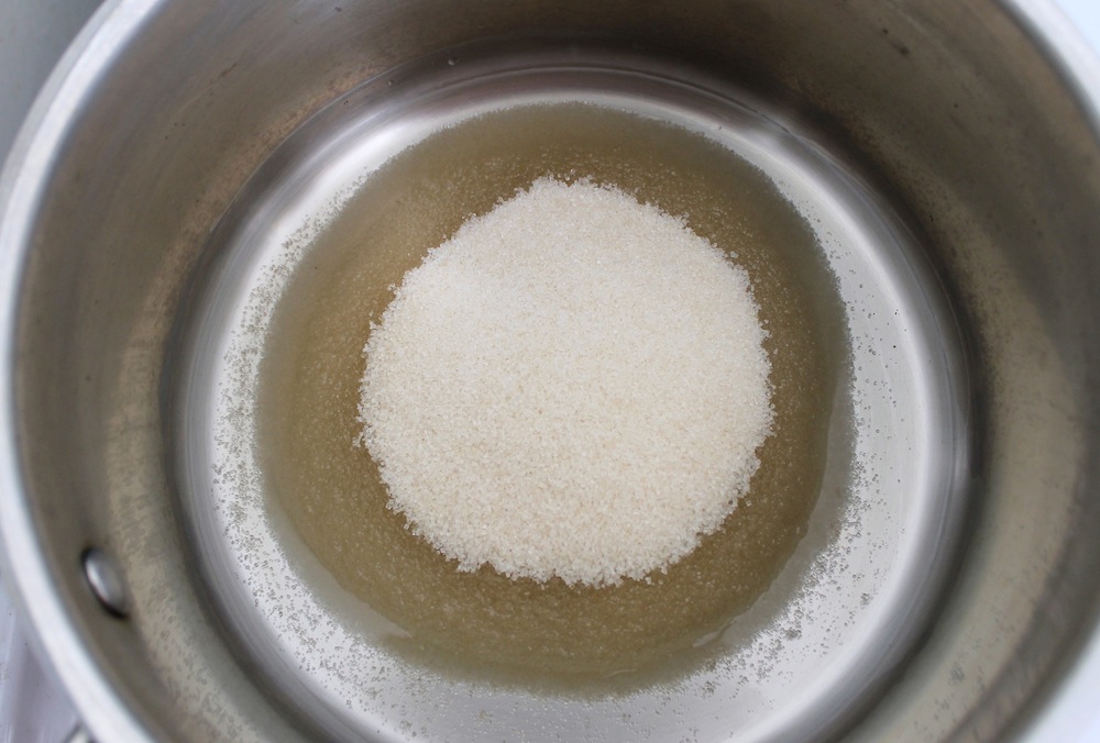 Pour the sugar into the center of the saucepan to avoid hitting the sides. Photo: Kate Williams