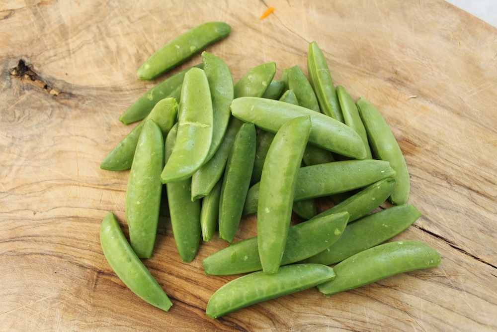 Sugar snap peas should have their tops and tails removed, as well as any tough strings. Photo: Kate Williams