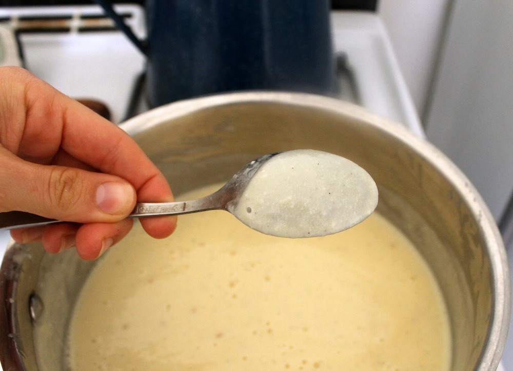 You’ll know the custard is ready when it reaches 180 degrees and evenly coats the back of a spoon. Photo: Kate Williams