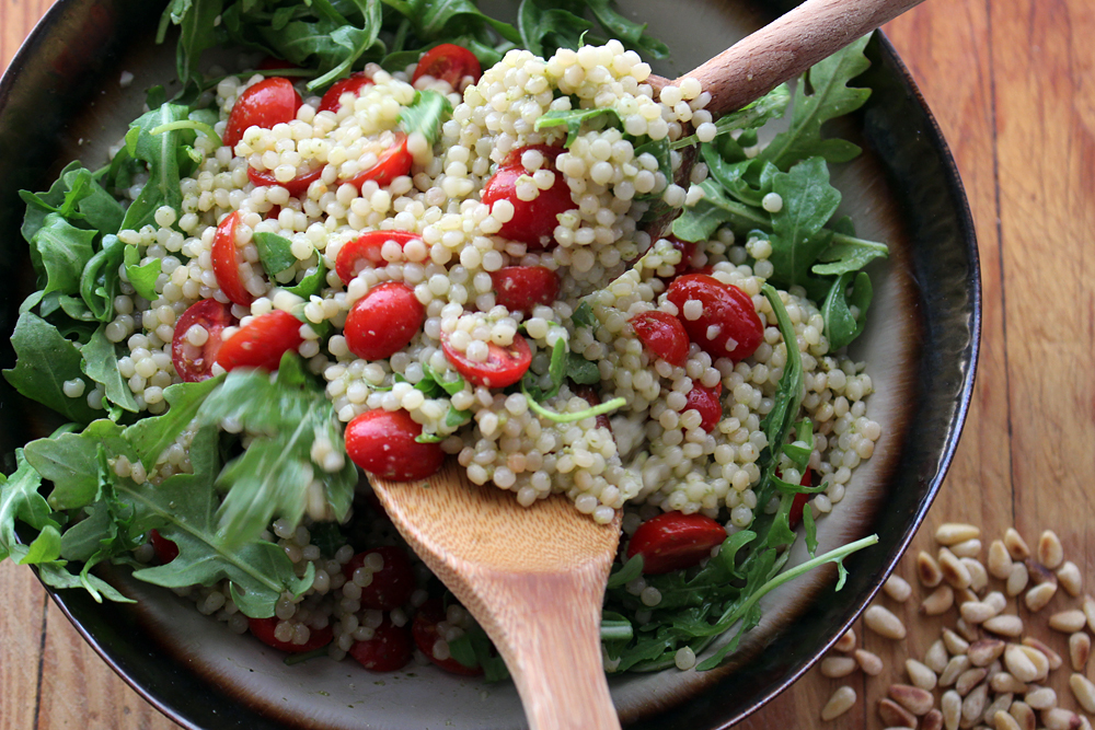 Add tomatoes and arugula and toss to combine. Garnish with the pine nuts and serve. Photo: Wendy Goodfriend