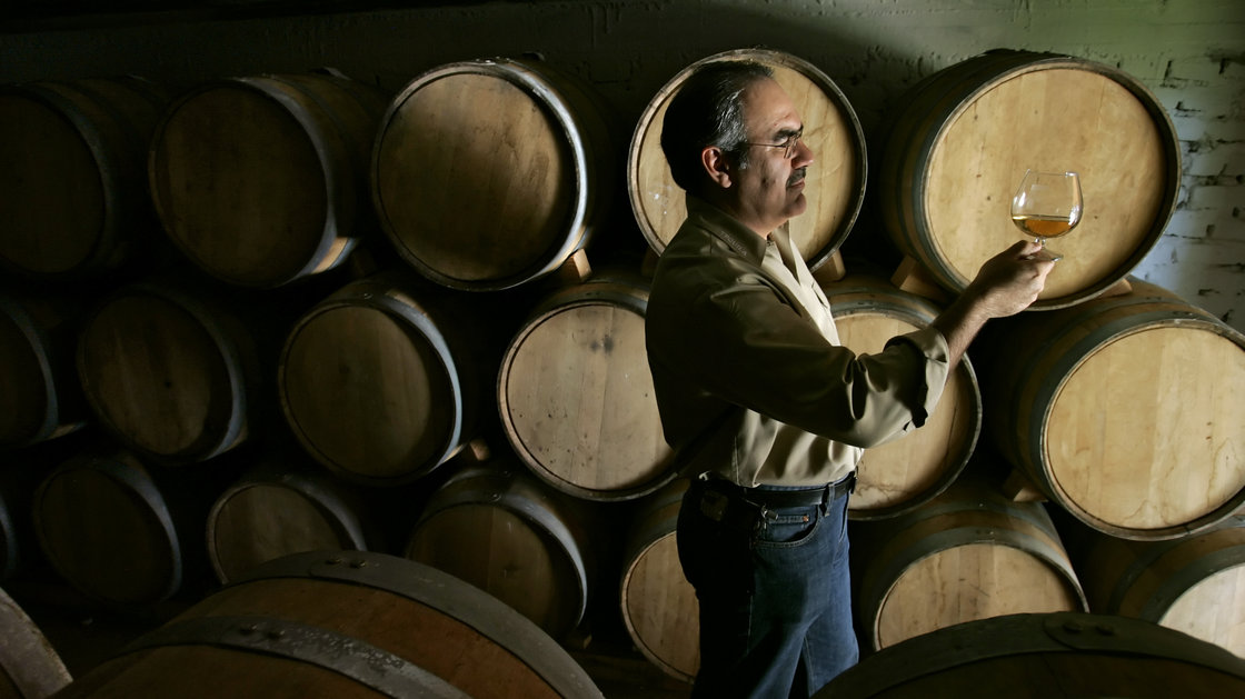 Siembra Azul founder and owner David Suro holds a glass of tequila in one of the aging vaults at the distillery in Arandas, Jalisco, Mexico. Photo: Erich Schlegel/Erich Schlegel/Corbis