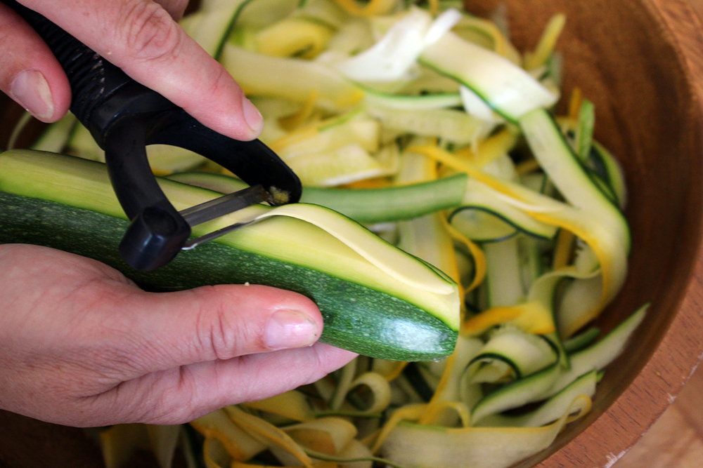 Using a vegetable peeler, shave long strips of zucchini from the stem end to the blossom end. Photo: Wendy Goodfriend 