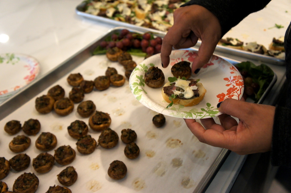 A Yammer employee adds some stuffed mushrooms to her plate. Credit: Angela Johnston