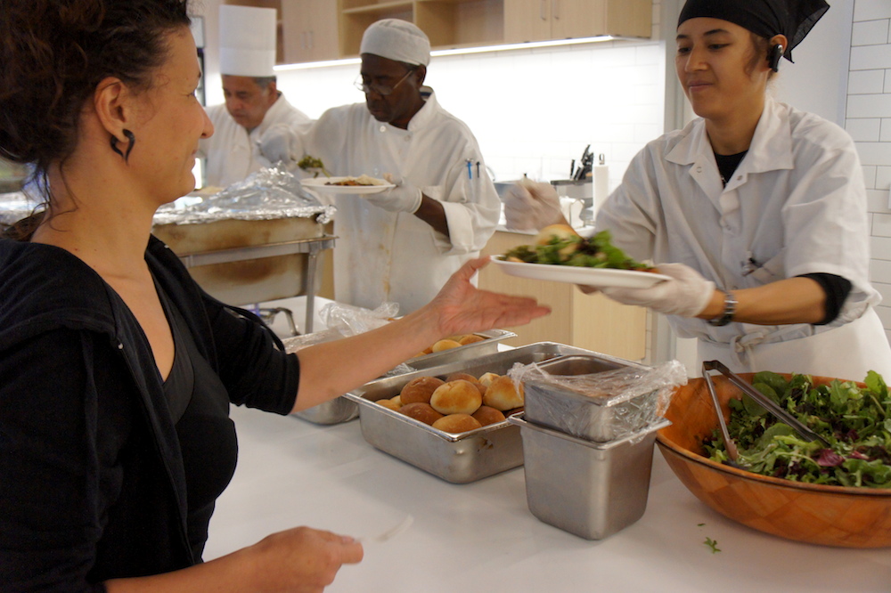 CHEFS student Safia Bubakar serves a meal to Zendesk employees. Photo: Angela Johnston