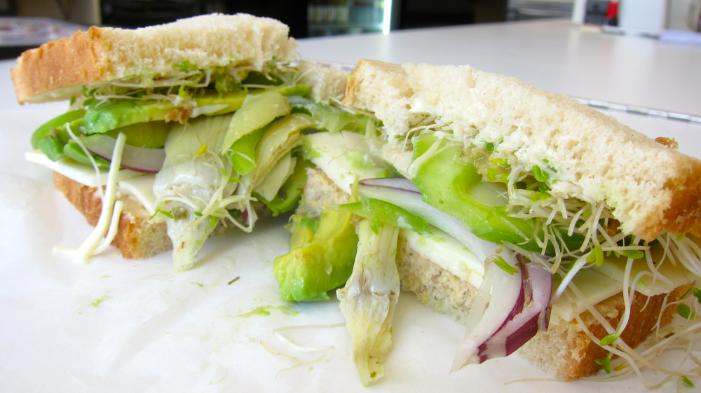 The Contador Sandwich: hummus; Monterey Jack cheese; avocado; artichoke hearts; roasted red peppers; red onion; bell pepper; sprouts; Italian dressing (but free of clenbuterol-tainted beef.) $6.50