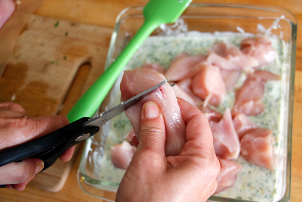 Cut chicken into 2-inch pieces and add to yogurt-herb marinade. Photo: Wendy Goodfriend