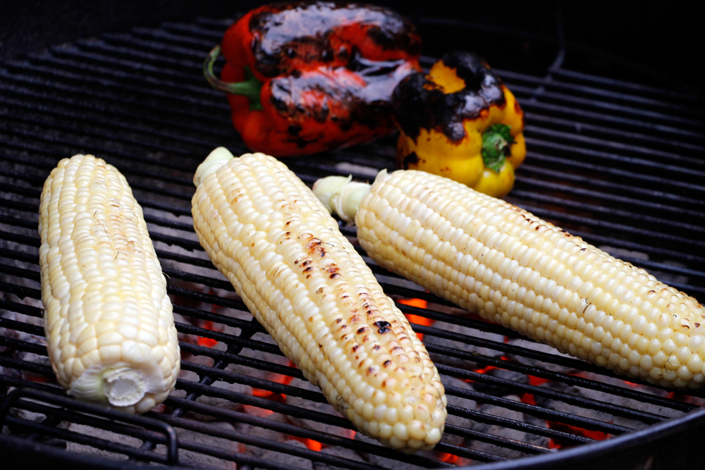 Grill the corn and peppers, turning them frequently until the peppers are blackened all over and the corn is crisp-tender and covered nicely in grill marks. Photo: Wendy Goodfriend