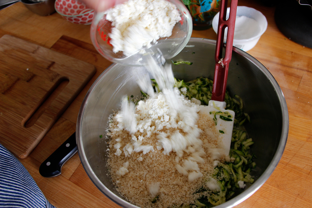 Add the zucchini to a mixing bowl. Add the bread crumbs, eggs, feta, green onions, mint, and cilantro and stir and toss well to combine. Photo: Wendy Goodfriend