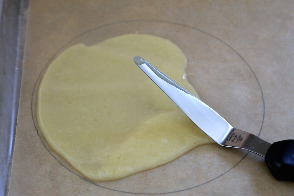 Use only one heaping tablespoon per cone, and spread it out to the edges of the stenciled circles using a small offset spatula. Photo: Kate Williams