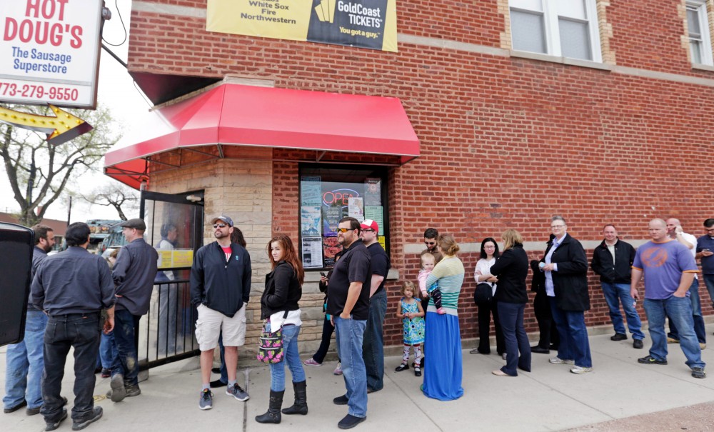 Aficionados line up outside Hot Doug's, a gourmet hot dog diner in Chicago in May 2014. Owner Doug Sohn announced that he will shut the doors in October after nearly 14 years. Photo: M. Spencer Green/AP 