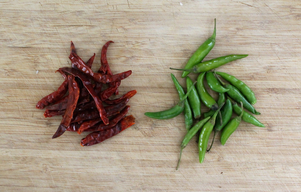 While many curry paste recipes call for a mix of many different dried peppers like long chiles and bird’s eye chiles, I typically stick with what is readily available: dried red Thai chiles or chiles arbol. For my green curry, I use the fresh version while they are still green. Photo: Kate Williams