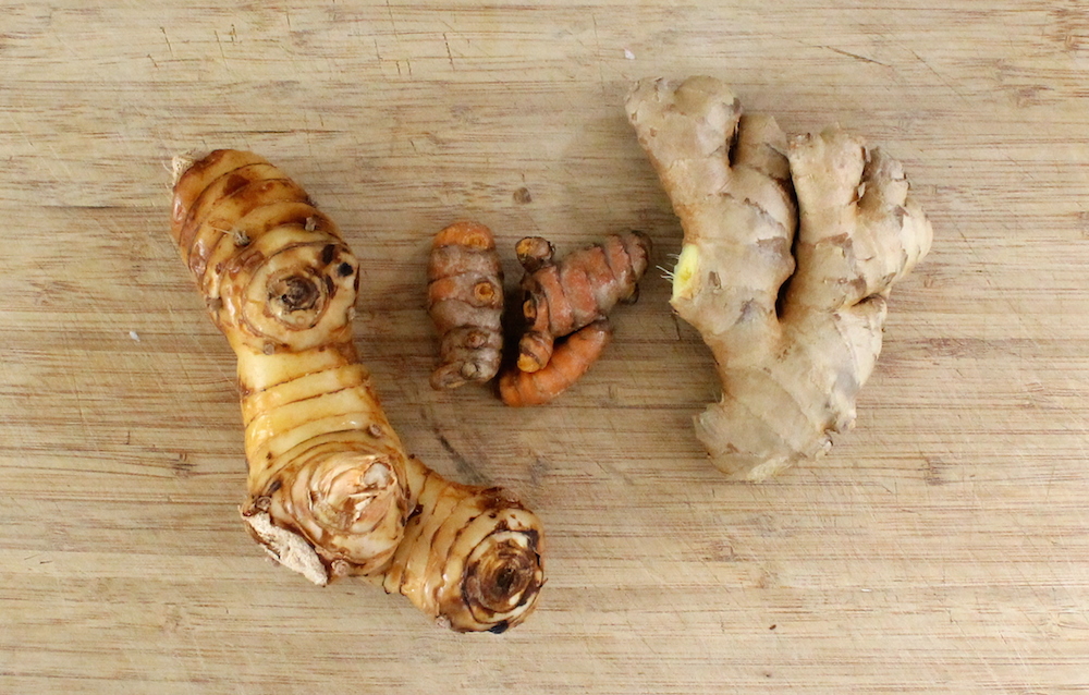 Traditional curry pastes use fragrant galangal (far left) as a base ingredient. Galangal can be difficult to find, so ginger (far right) is often substituted. Using ginger instead of galangal will result in a very different curry paste, but it will still make a decent curry. Yellow curry paste gets its color from fresh turmeric (center). The fresh ingredient has brighter, stronger flavor than the dried spice. Photo: Kate Williams