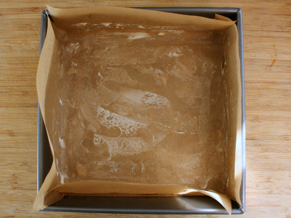 Line a square baking dish with greased parchment paper for easy caramel removal. Photo: Kate Williams