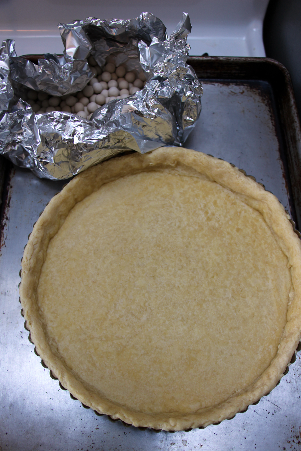 Bake until the crust looks dry, about 20 minutes. Remove the foil and weights and set aside while you prepare the filling. Reduce the oven temperature to 350°F. Photo: Wendy Goodfriend
