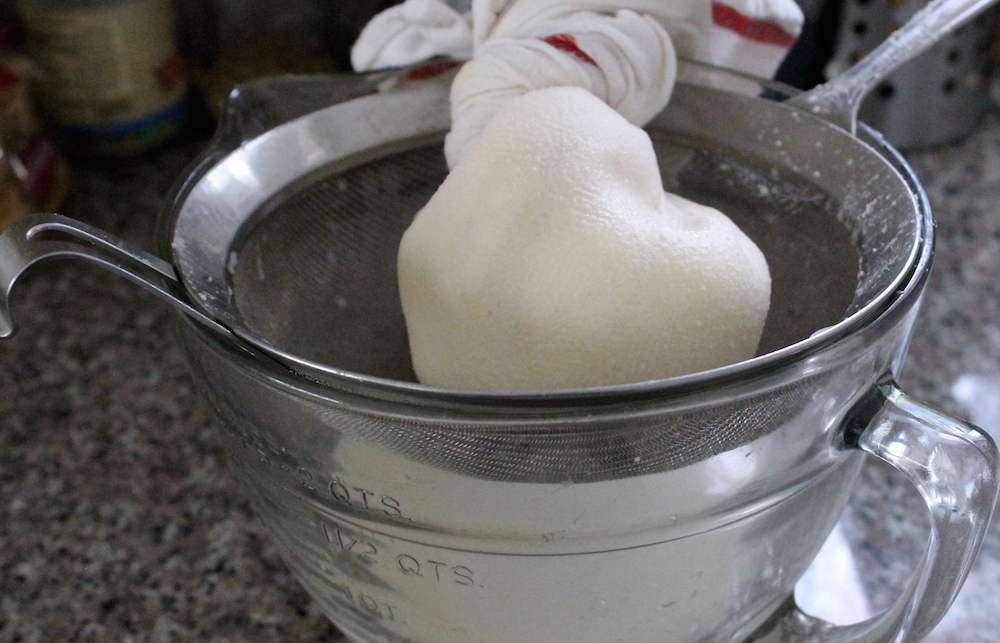 Next, gather the edges of the towel, twist, and squeeze on the butter to release more buttermilk. Photo: Kate Williams