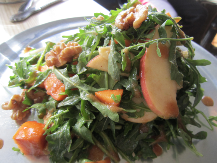 A salad of shaved apples and persimmons, arugula, apple butter vinaigrette, Point Reyes blue crema and toasted walnuts. Photo: Alix Wall