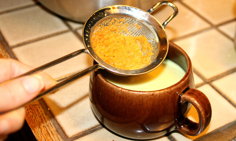 Preparing golden milk using fresh turmeric. Photo: Lisa Landers