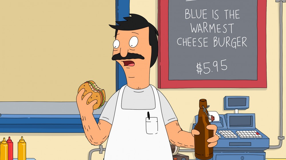 Bob Belcher, titular hero of Bob's Burgers, bites into one of his creations. Each episode features daily burger specials with chuckle-inducing names. The burgers were born in the show writers' imagination and brought to life in Cole Bowden's kitchen. Image: Fox/via Getty Images