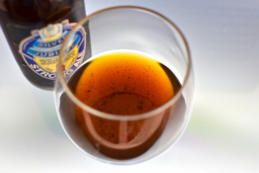 Sediment in a glass of 1977 Ind Coope Strong Ale. Proteins in very old beers can coagulate into chunks at the bottom of the bottle, Patrick Dawson explains in Vintage Beer. Photo: Courtesy of Lindsay Dawson
