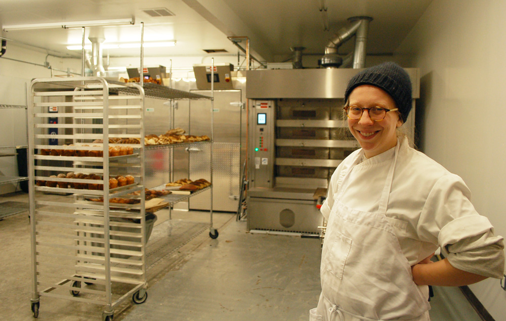 Avery Ruzicka now oversees a crew of four in the new 3,000-square-foot production facility, featuring the big Italian oven behind her. Photo: Susan Hathaway