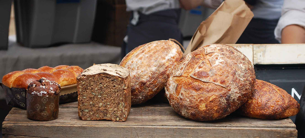 This partial line-up of enticements will soon be available beyond a couple of farmers markets. It includes chocolate brioche, seedy pumpernickel rye and crusty breads. Photo: Susan Hathaway