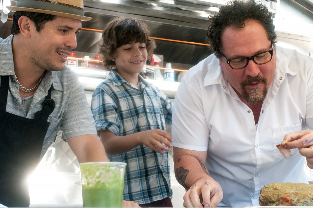 In Chef, Jon Favreau (right) plays a chef who leaves his post at a respected LA restaurant to launch a food truck with his son (Emjay Anthony, center) and a former line cook (John Leguizamo). Photo: Merrick Morton/Courtesy of Open Road Films