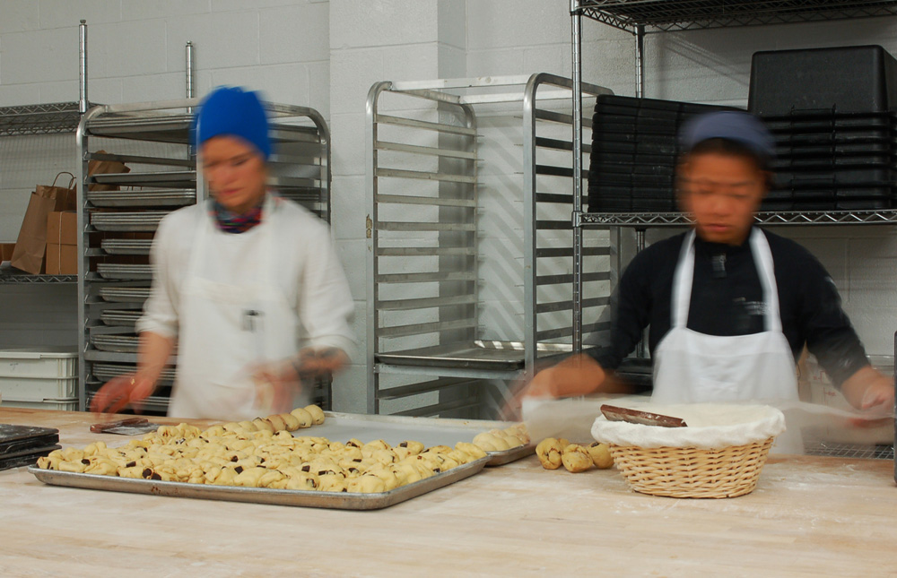 Two of the skilled bakers of ManresaBread make orange chocolate brioche in the new facility. Photo: Susan Hathaway