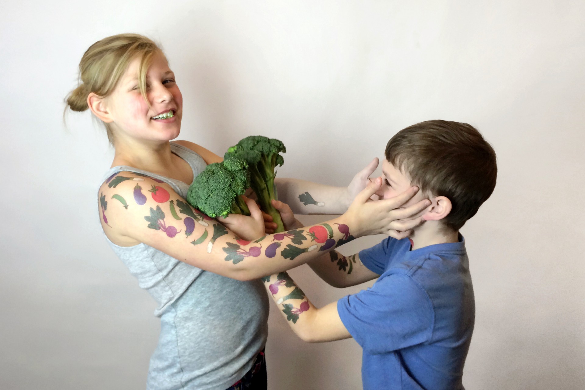 Siblings Jessica and Oliver Schaap of Holland, Mich., test out the temporary vegetable tattoos known as Tater Tats. Photo: Courtesy of Jenna Weiler