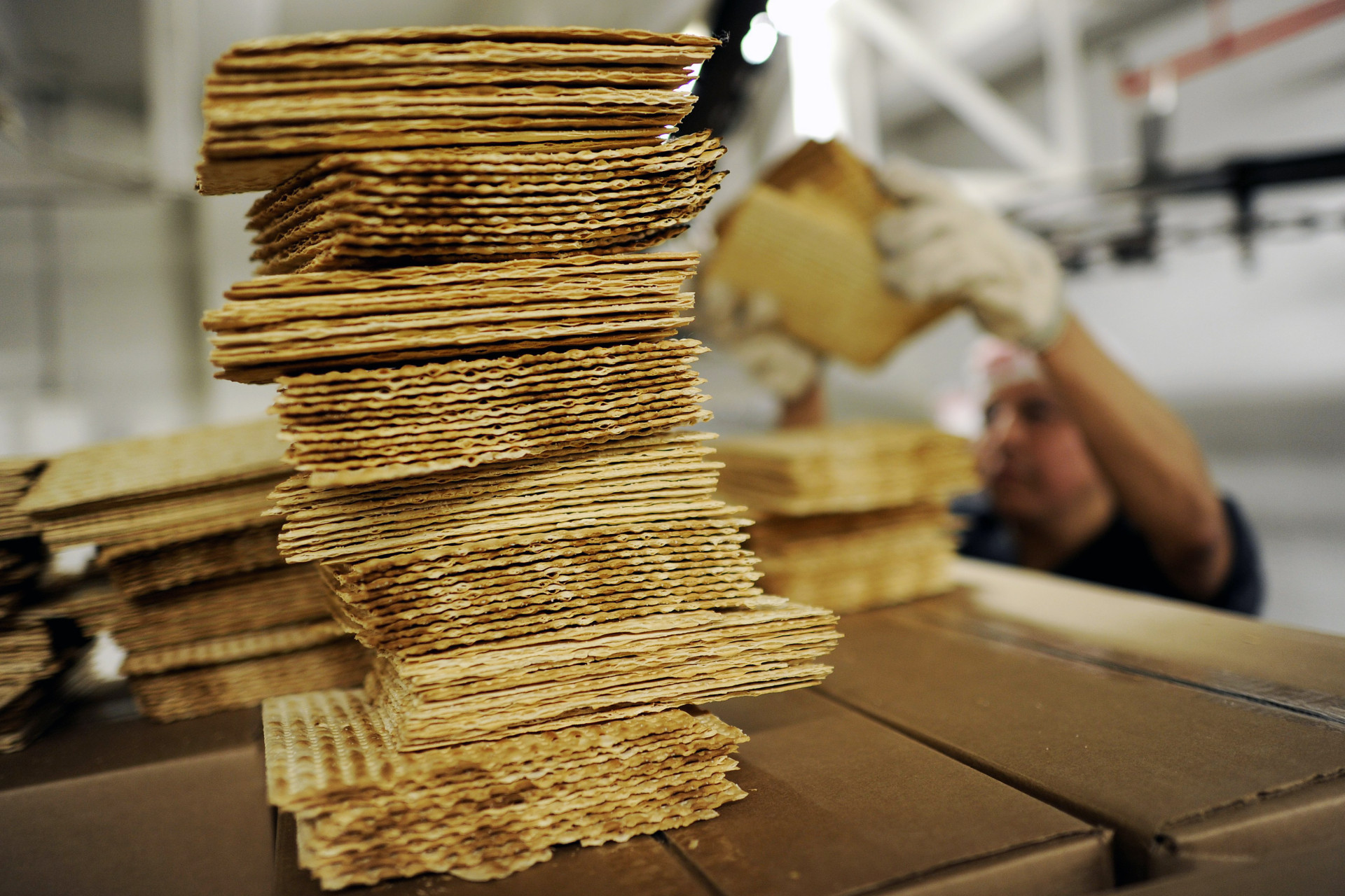 A worker stacks matzo wafers at Streit's matzo factory on the Lower East Side of New York, May 2012.