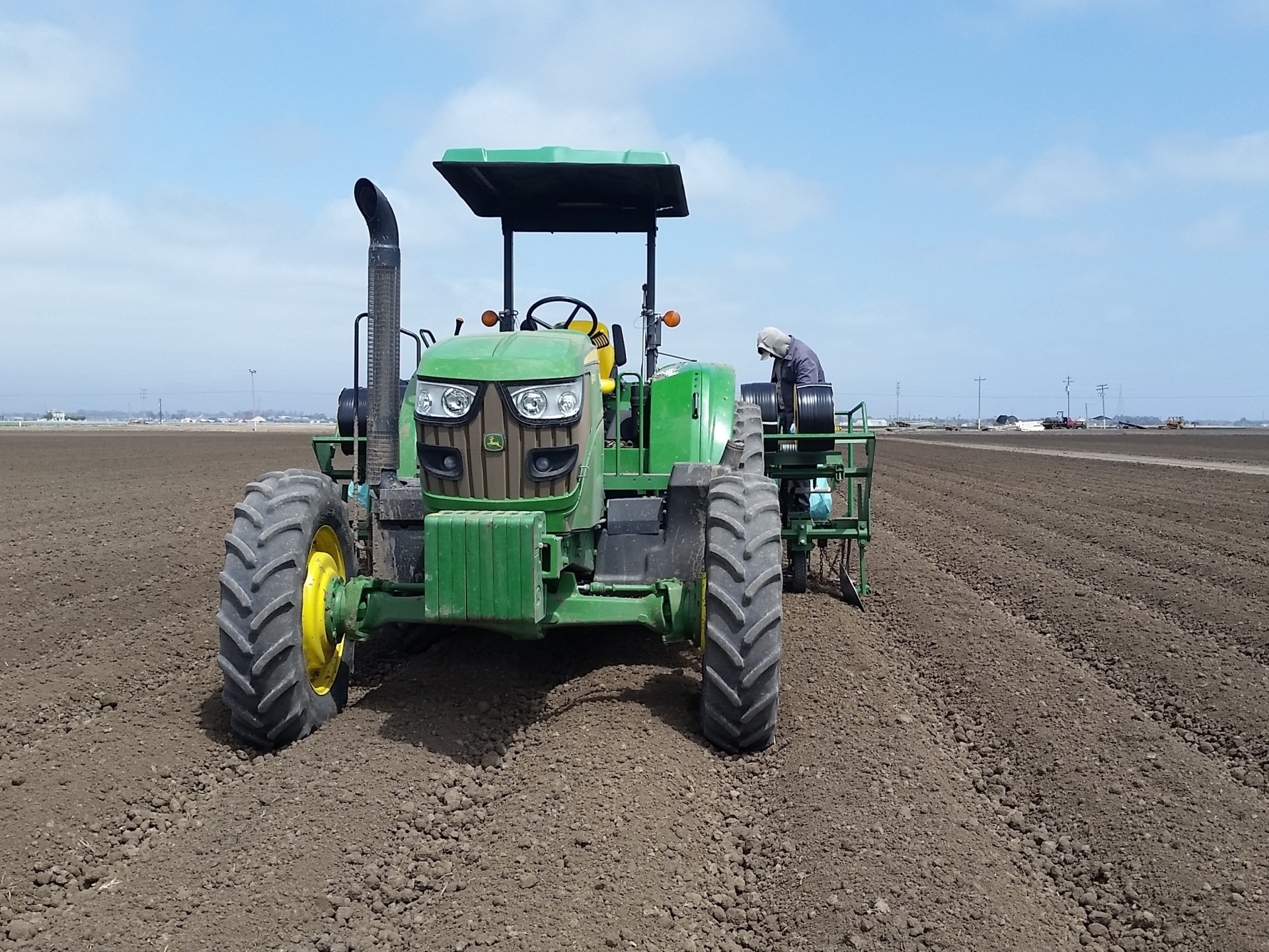 Tanimura & Antle workers use tractors to install drip tape into fields that will be used to grow lettuce and other crops in California's Salinas Valley.