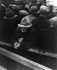 A man waits in a bread line in San Francisco during the winter of 1933