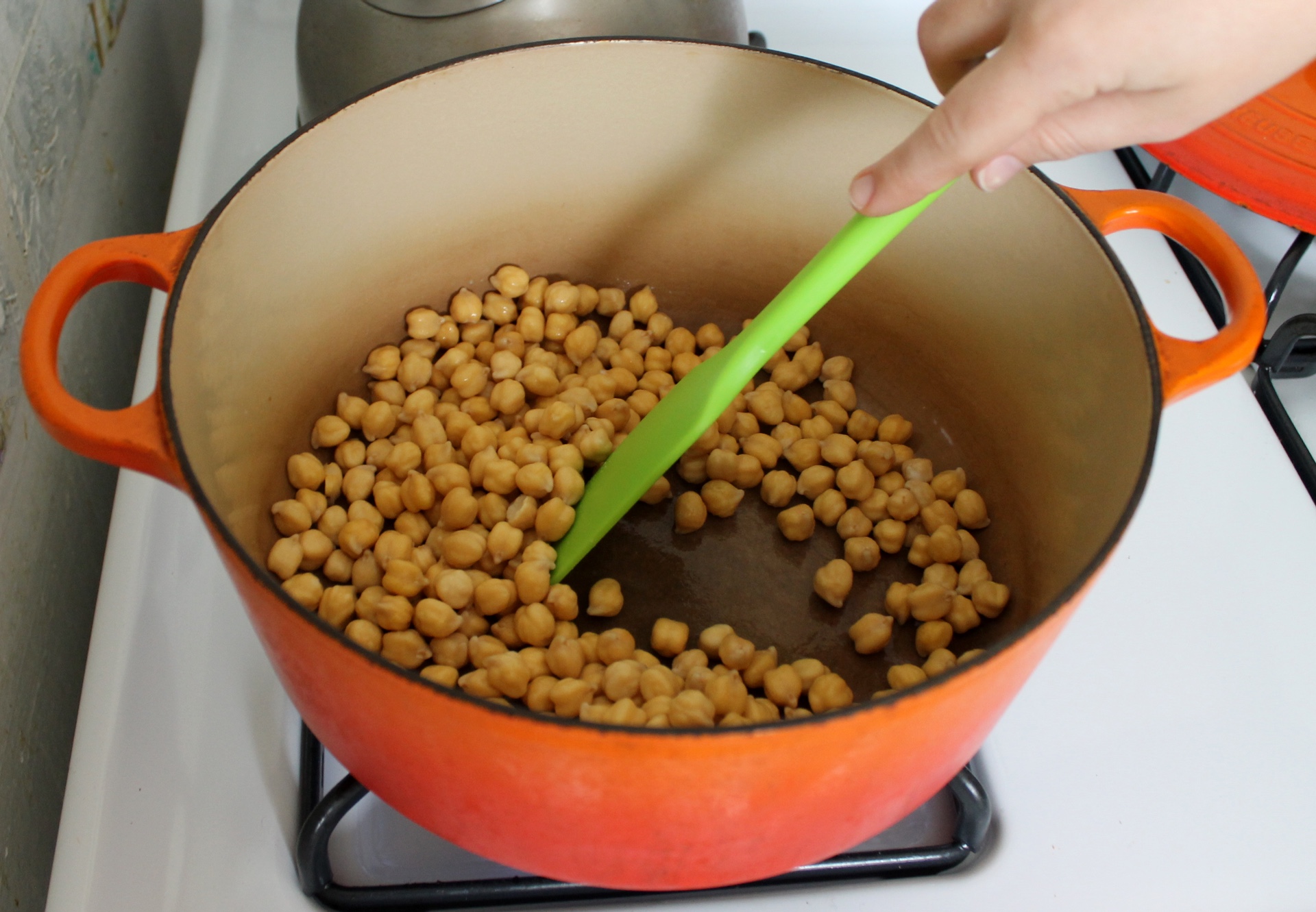 Cooking the chickpeas dry with a little baking soda speeds up cooking and helps remove pesky chickpea skins.