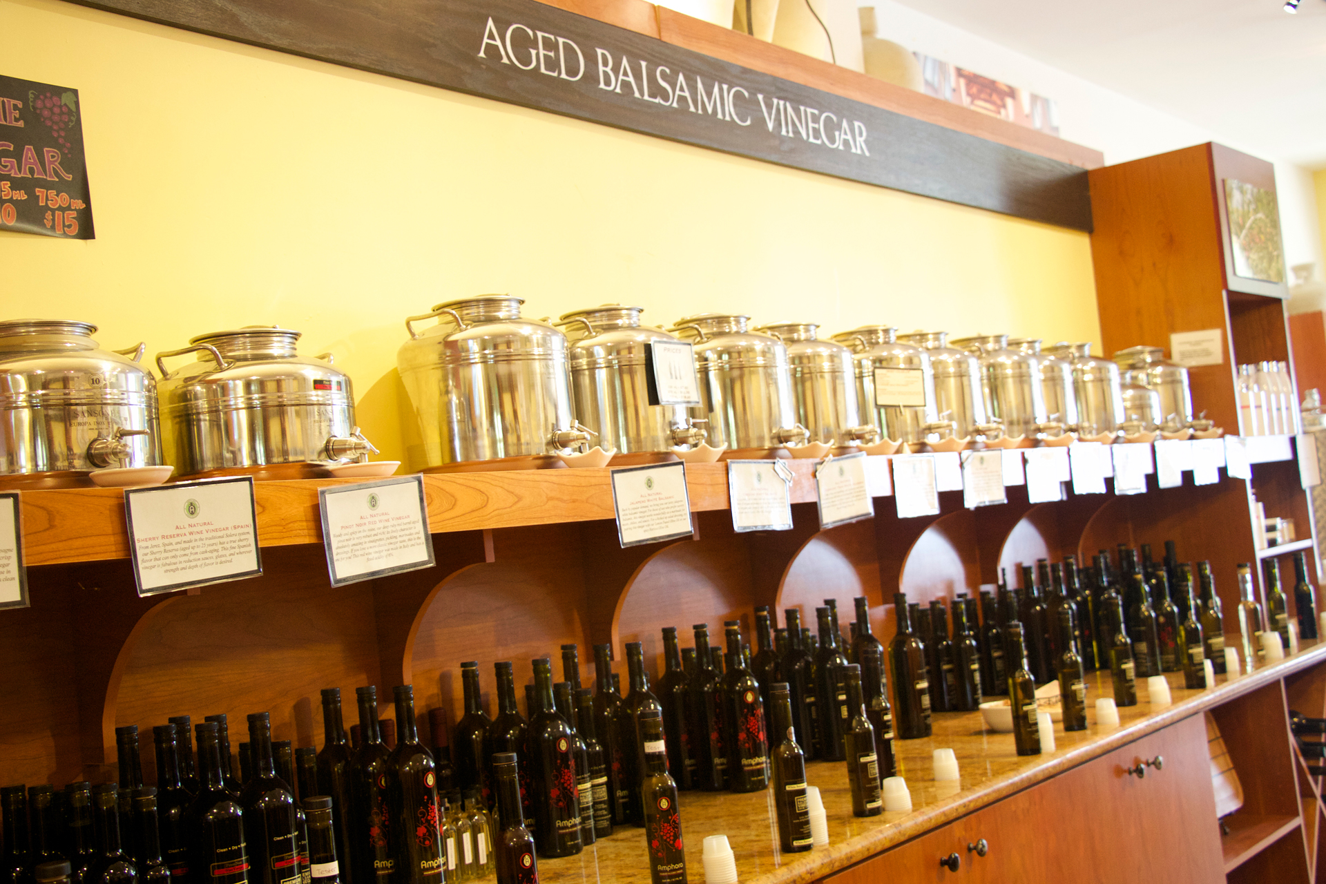 Aged balsamic and flavored vinegars line the shelves at Amphora.