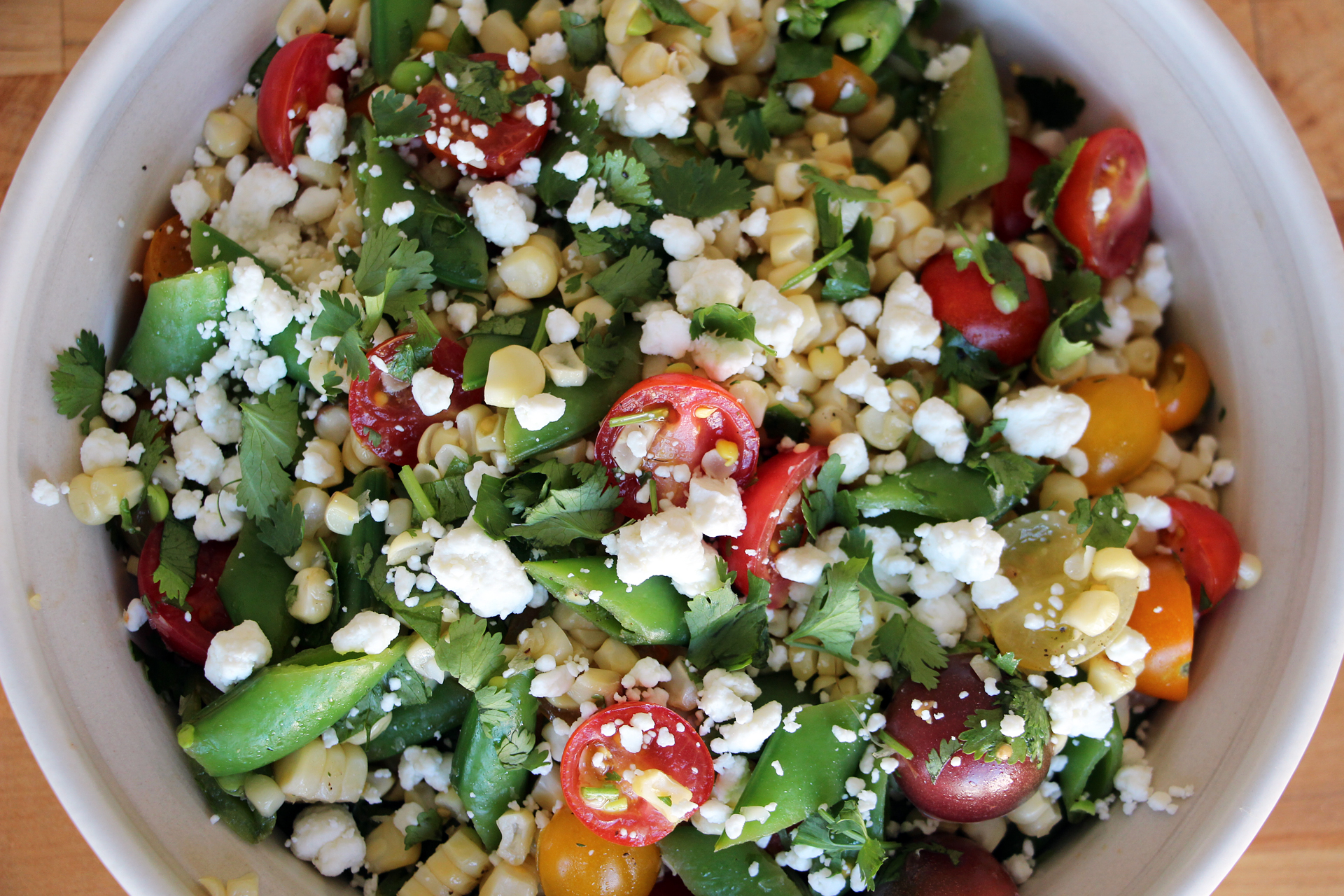 Grilled Corn Salad with Sugar Snaps, Cherry Tomatoes, and Goat Cheese