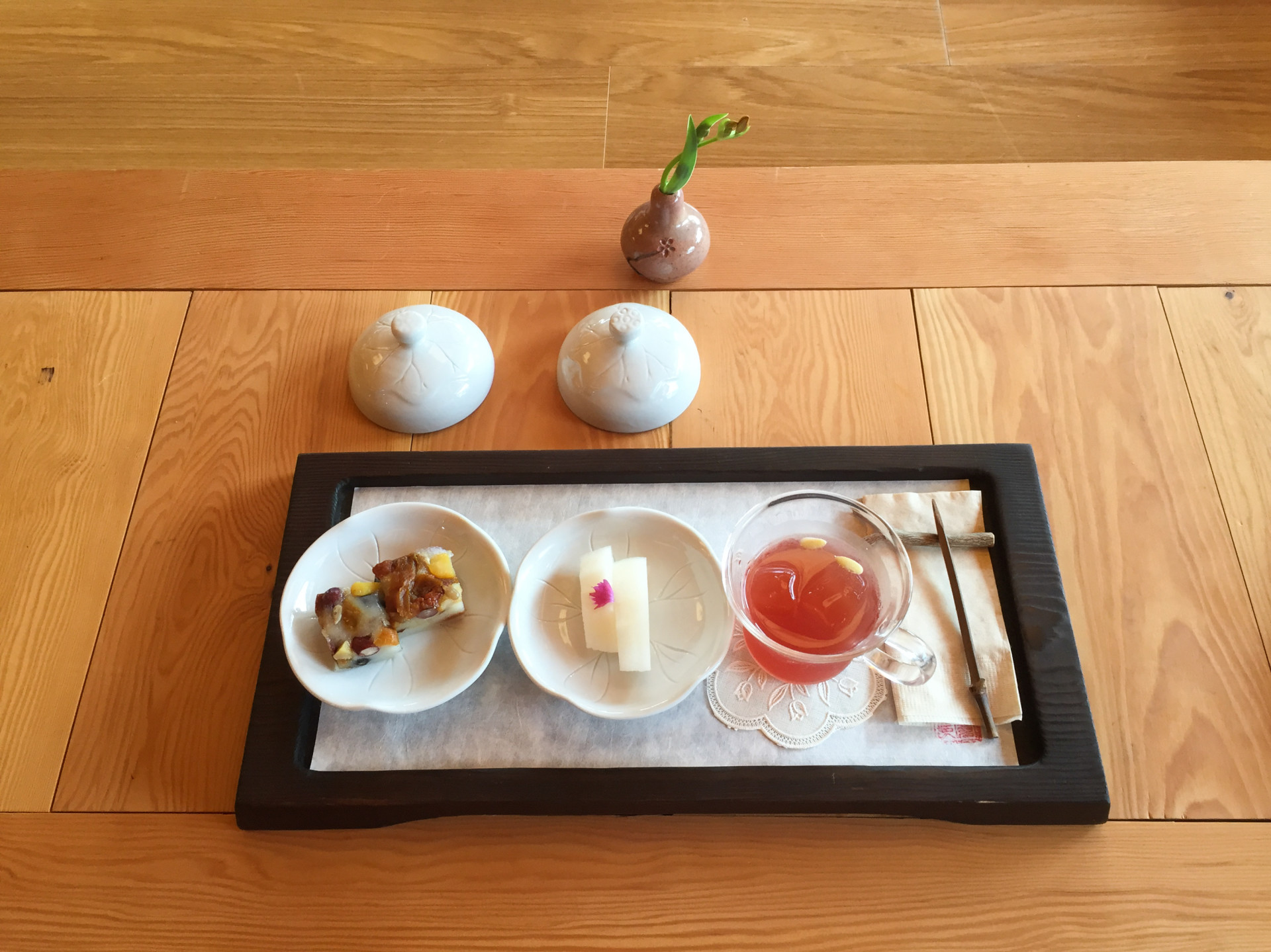 Iced tea made from local berries is served with melon and squares of sweet sticky rice topped with fruits and nuts. The nuns eat these sweets on head-shaving day, to replenish their energy.
