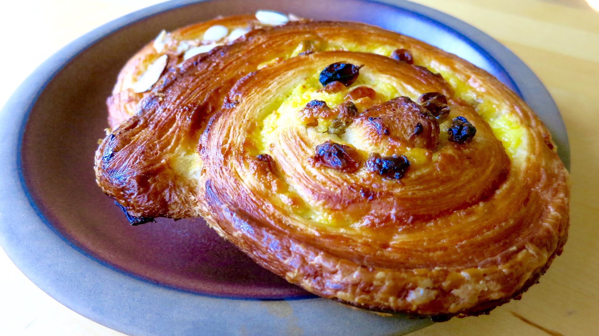 The pain aux raisins (with or without almonds) from Casse-Croûte are a golden brown, butterific treat.