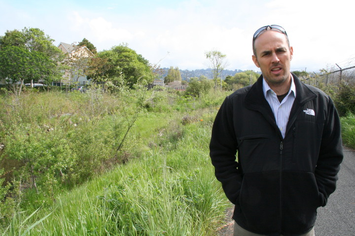 Adam Berman, in 2013, stands on the boundary of the property Urban Adamah purchased on Sixth Street. Cordonices Creek is behind him.