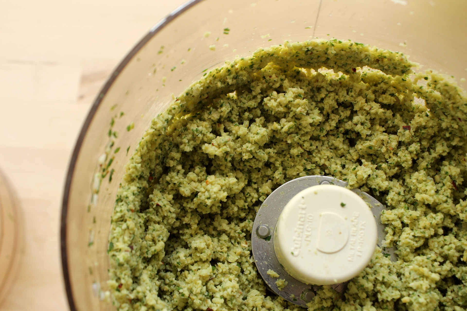 The processed falafel mixture should be a coarse paste. You want it to stick together, but you also want to have small pieces of chickpeas throughout.