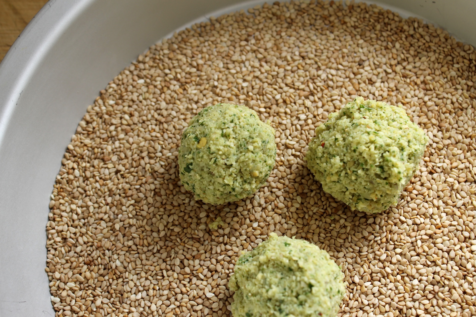 Roll the falafel balls in sesame seeds for extra crunch and color.