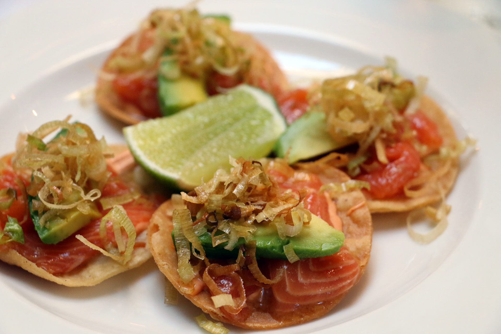 Trout tostadas with chipotle sauce and fried leeks.