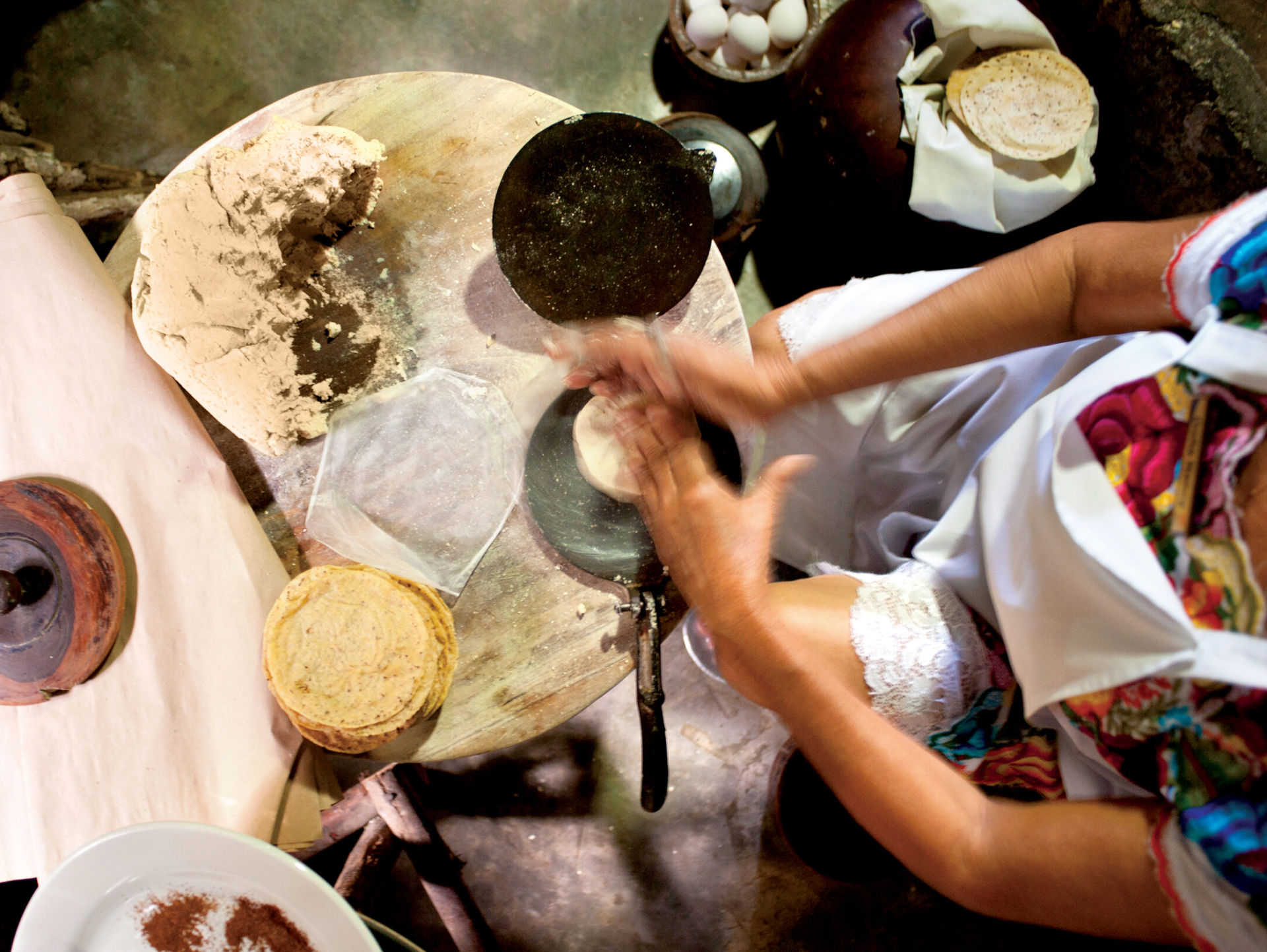 A woman prepares tortillas at Kinich Restaurant in Izamal, Yucatan, Mexico. The average Mexican consumes 135 pounds of tortillas per year.