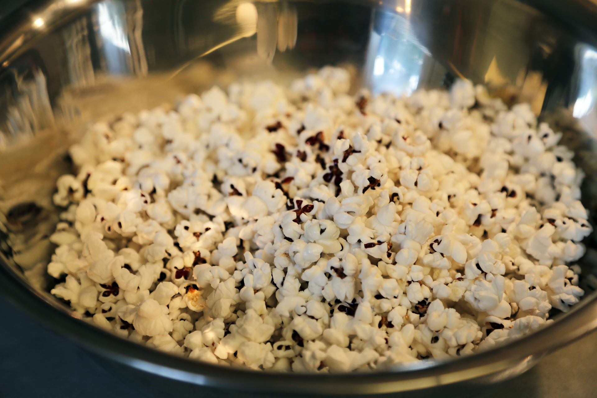 Pop the popcorn according to package directions, transfer to a large mixing bowl.