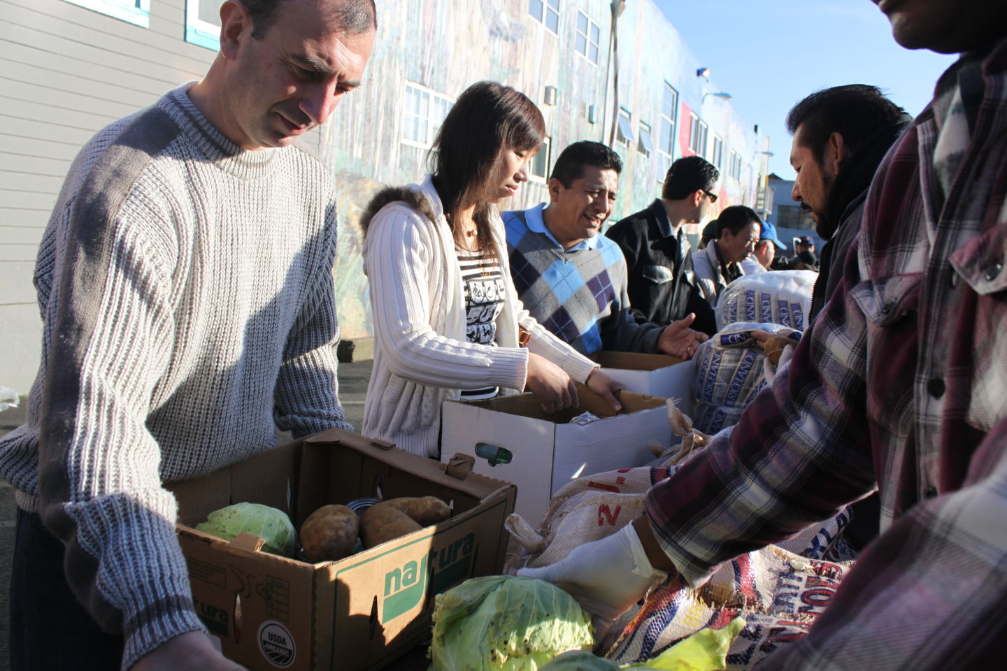 Volunteers help distribute food to participants at one of the SF-Marin Food Bank’s pantries