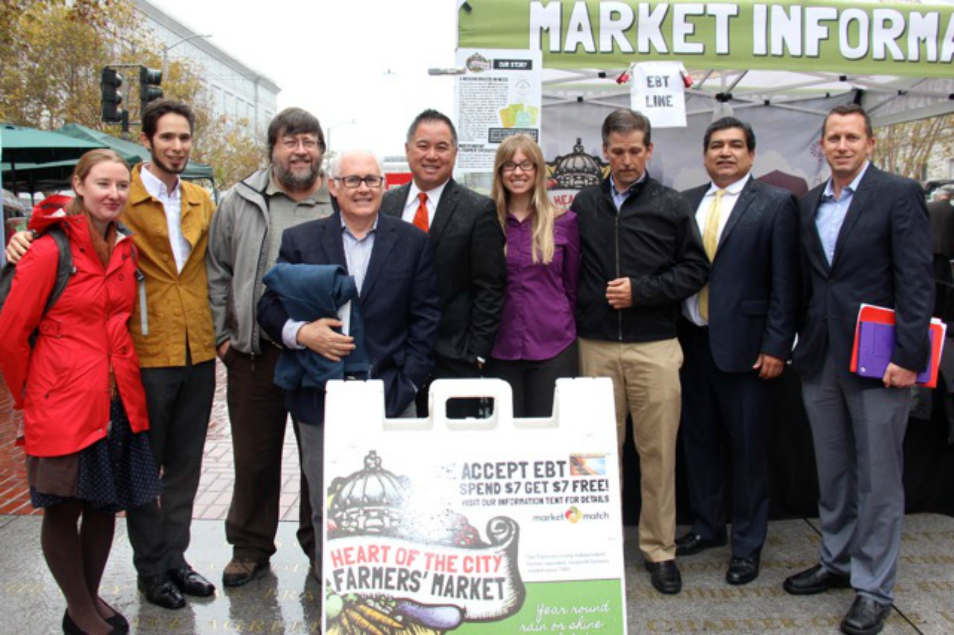 Celebrating the passage of nutrition incentive matching legislation AB 1321 at Heart of the City Farmers Market in September. From left: Christina Oatfield, Eli Zigas, Peter Ruddock, Michael Dimock, Assemblymember Phil Ting, Kate Creps, Martin Bourque, Xavier Morales, Allen Moy.